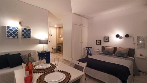 a bedroom with a bed and a living room at Studio At The Beach in Alvor