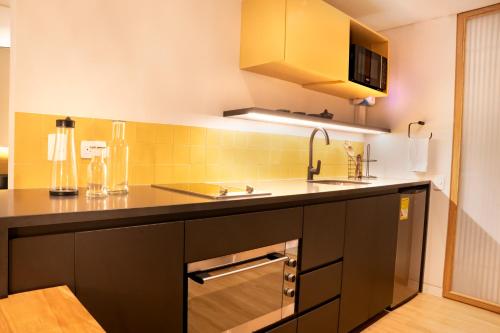 a kitchen with a sink and a counter top at Topá House in Medellín