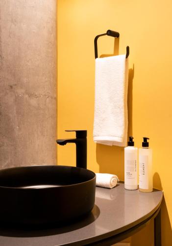 a bathroom counter with a sink and a towel at Topá House in Medellín