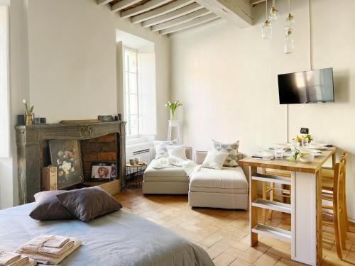 a living room with a bed and a table in it at Lovely nest in Parma centro in Parma
