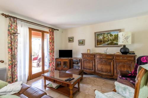 a living room with a couch and a table at Nice Duplex With Garden Terrace And Garage in Six-Fours-les-Plages