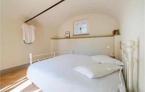 a white bed in a room with a window at Nice Apartment In Bastia Di Albenga in Albenga