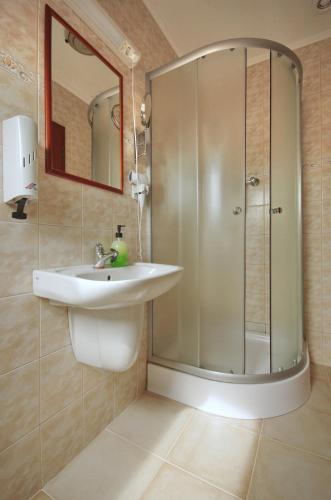 a bathroom with a sink and a shower at Guest House Romantika Panzio in Gyula