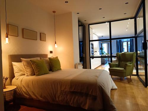 a bedroom with a bed and a chair in a room at Residencial Gijón Centro in Gijón