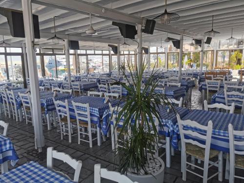 a restaurant with blue and white tables and chairs at Y & P LATCHI HOTEL in Lachi