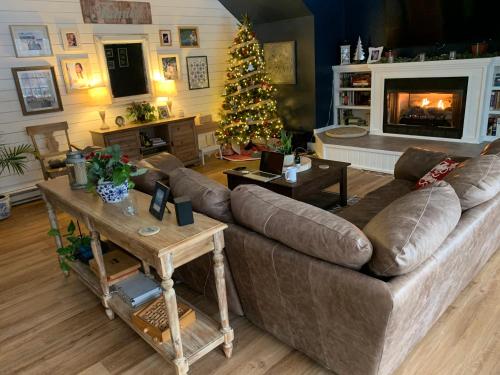 a living room with a couch and a christmas tree at Morning Glory Inn in Slaty Fork