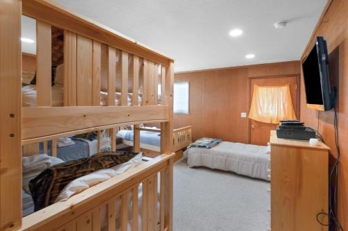 a room with two bunk beds and a flat screen tv at Centrally Located and Dog Friendly! - Home #36 in Bear Valley