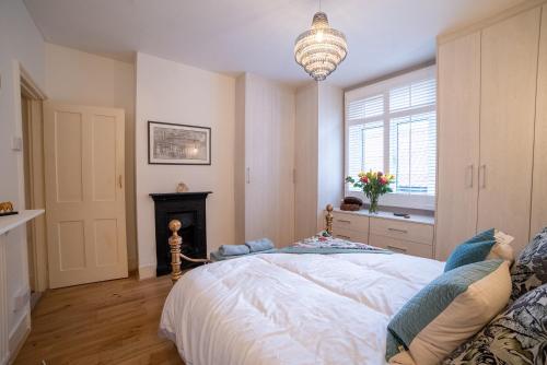 - une chambre avec un grand lit et une cheminée dans l'établissement Waterman's Cottage, à Kent