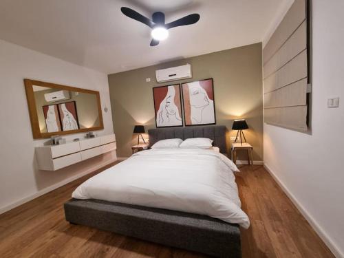 sypialnia z dużym łóżkiem i wentylatorem sufitowym w obiekcie Hadar Rest & Relax w mieście Kefar H̱ittim