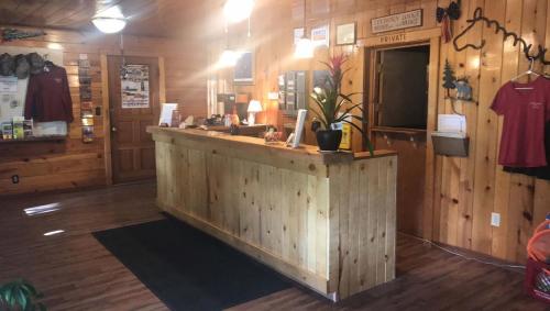 a wooden bar in a store with a counter at Elkhorn Lodge in Chama