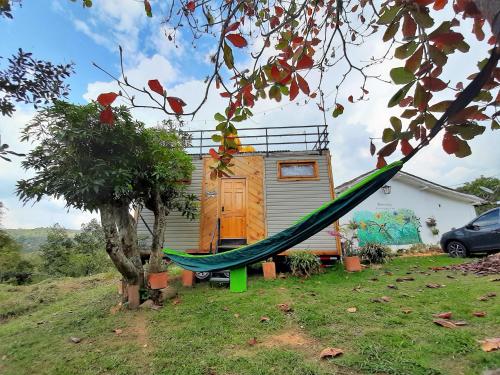 a house with a hammock in front of it at Mini casa San Gil-Mogotes in San Gil