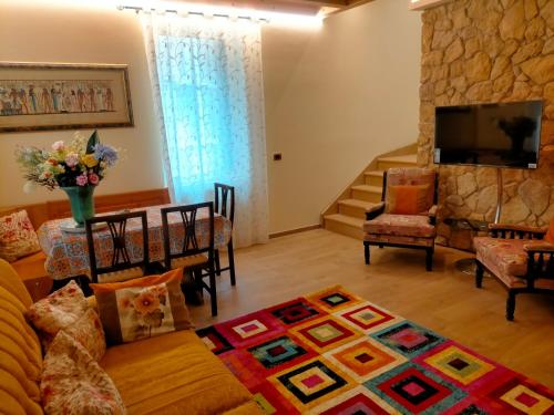 a living room with a couch and a table at Verona City Arsenale Apartment in Verona