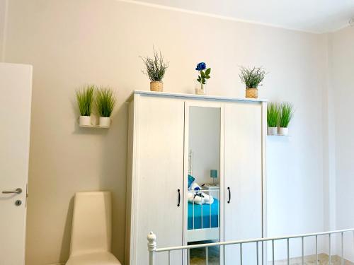 a cabinet with plants on top of it in a room at Apartment Savoia in Bari