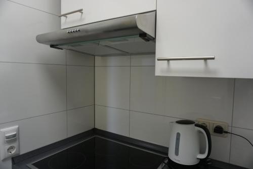 a kitchen with a sink and a paper towel dispenser at Bett3de in Erding