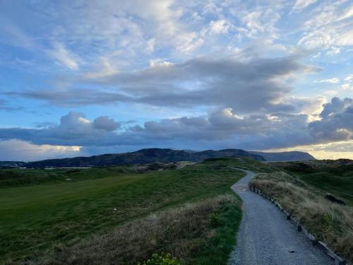 a winding road in the middle of a grassy field at Merrion Hotel in Llandudno