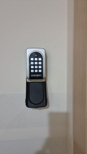 a cell phone sitting on top of a shelf at Harmony Apartments in Podgorica