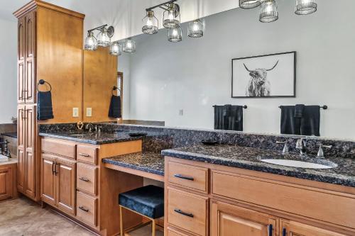 a bathroom with two sinks and a large counter at Spacious Murphy Cabin with Game Rooms and Mtn Views! in Murphy