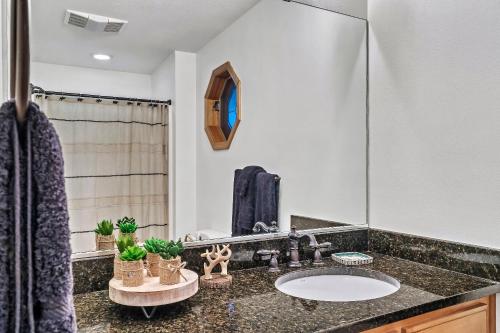 a bathroom with a sink and a mirror at Spacious Murphy Cabin with Game Rooms and Mtn Views! in Murphy