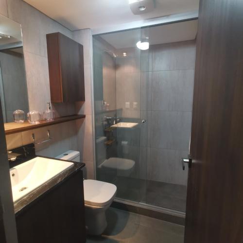 a bathroom with a shower and a toilet and a sink at Cosmopolitan 502 in La Paz