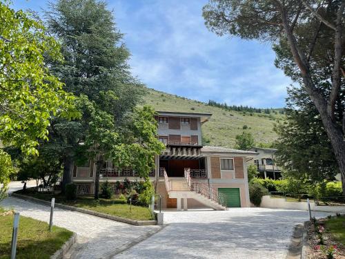 a large house with a hill in the background at Villa Marchionni in Cese