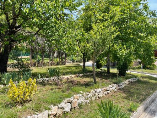 a garden with trees and rocks in a park at Villa Marchionni in Cese
