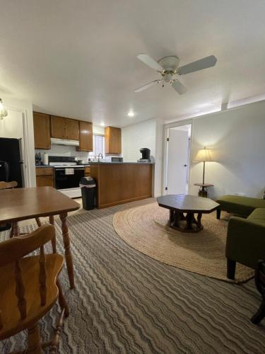a living room with a table and a kitchen at The Aztec Motel & Creative Space in Seligman