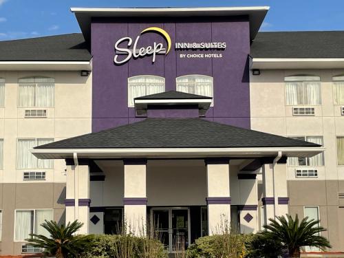 a purple building with a sign on top of it at Sleep Inn & Suites in Foley