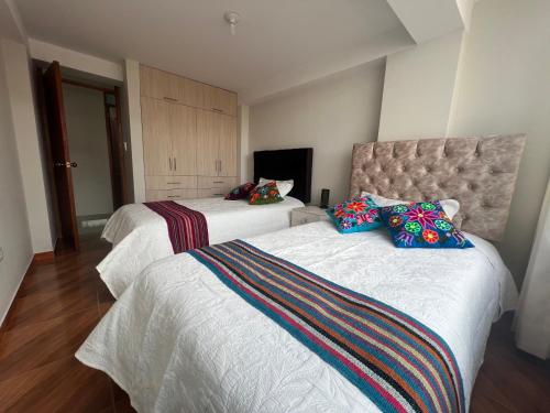 a hotel room with two beds in a room at Residencial Chávez Concha / Cusco in Cusco