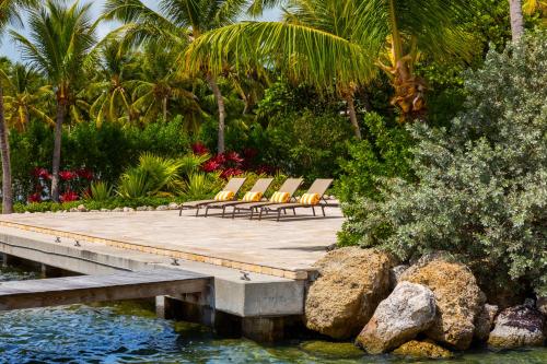 a group of chairs sitting on a wooden dock at La Siesta Resort & Villas in Islamorada