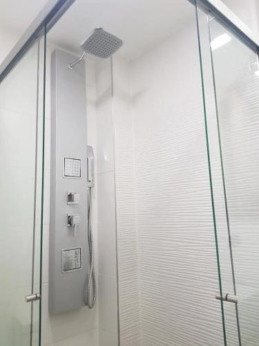 a shower with a glass door in a bathroom at Zenia 70 Living & Suites in Medellín