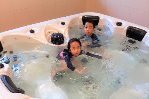 a man and a child in a bathtub at Johor Malaysia Teega Suites@ Puteri Harbour Condo 4607 Persiaran Lasamana , Teega Suites in Nusajaya