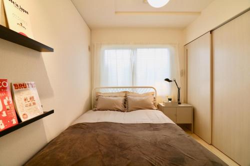 Posteľ alebo postele v izbe v ubytovaní Hassamu 3 Jo 1-11-1 Corole Kotoni - Vacation STAY 11465