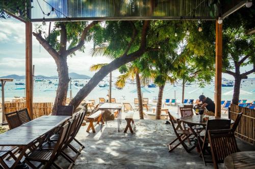 a restaurant with tables and chairs on the beach at Villa Đảo Hoa Vàng Cam Ranh - Venuestay in Cam Ranh