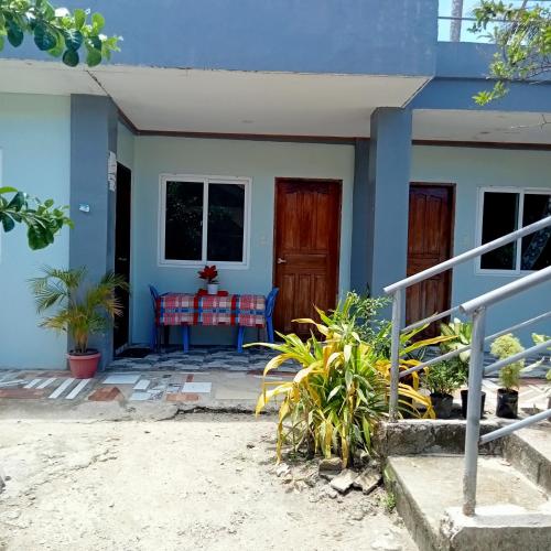 a small house with a blue at JANHOUR PLACE in San Vicente