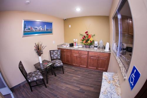 a hospital room with a waiting area with chairs and a counter at GAREY MOTEL in Pomona