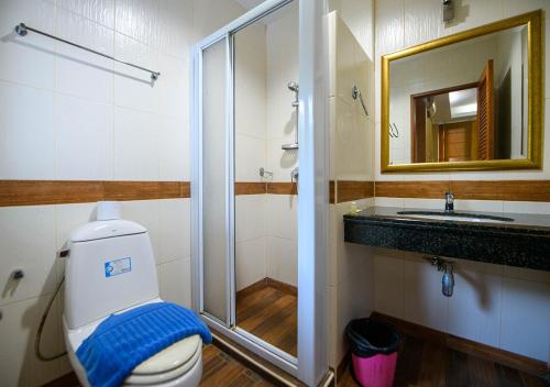 a bathroom with a shower and a toilet and a sink at 4 Bedroom Town Villa With Private Pool in Pattaya South