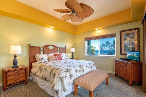 a bedroom with a bed and a ceiling fan at Kahalu'u Beach Villas 1-203 in Kailua-Kona