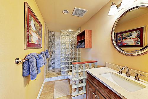 a bathroom with a sink and a shower and a mirror at Kahalu'u Beach Villas 1-203 in Kailua-Kona