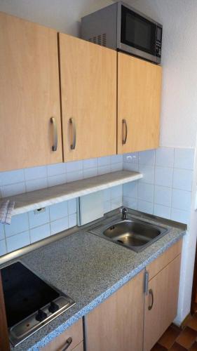 a kitchen with a sink and a microwave at Sonnleiten-Rupert in Bad Griesbach