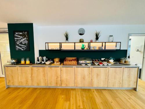 a kitchen with a counter with food on it at Creo München Süd in Munich