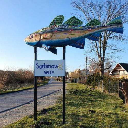 a sign with a fish on top of a street at ATRIUM Sarbinowo Na Fali in Sarbinowo