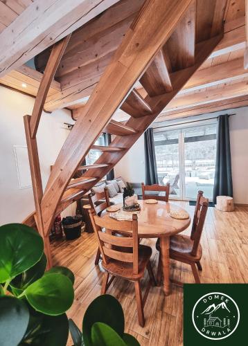 a dining room with a wooden table and chairs at Domek Drwala k. Karpacza in Sosnówka