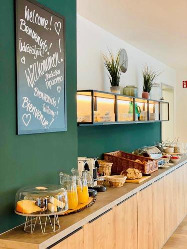 a bakery with a counter with food on it at Creo München Süd in Munich