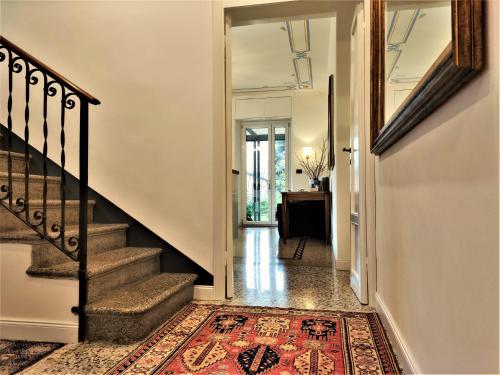 a hallway with stairs and a rug on the floor at Residenza Laurum in Mandello del Lario