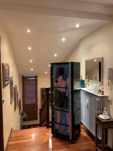 a large black refrigerator in a room at B&BMagicHouse in Novara