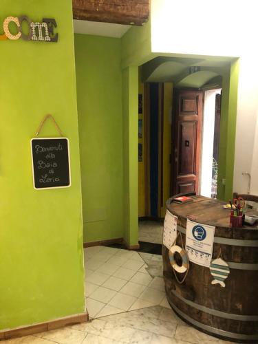 a room with a barrel and a sign on the wall at Affittacamere La Baia Di Lerici in Lerici
