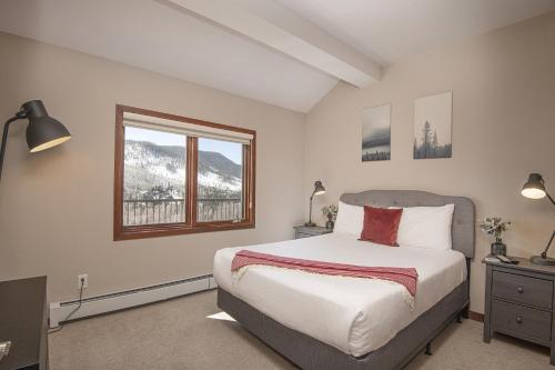a bedroom with a bed and a window at Vail Point 7 townhouse in Vail