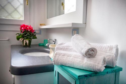 a bathroom with a sink and towels on a counter at Villa Isuledda Prestige in San Teodoro