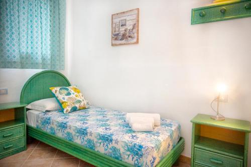 a small bedroom with a bed and two night stands at Villa Isuledda Prestige in San Teodoro