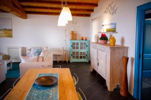 a living room with a table and a couch at Villa Isuledda Prestige in San Teodoro